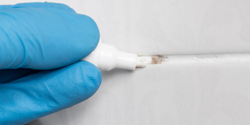 A grout pen restoring the appearance of grout between tiles