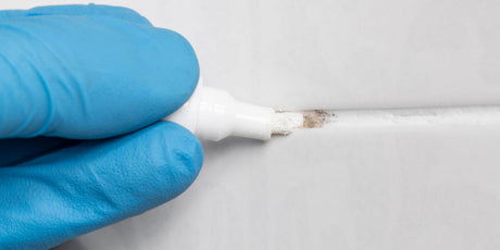 A grout pen restoring the appearance of grout between tiles