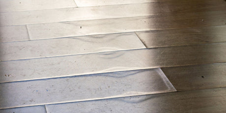 Close-up of a floor with visible delamination.